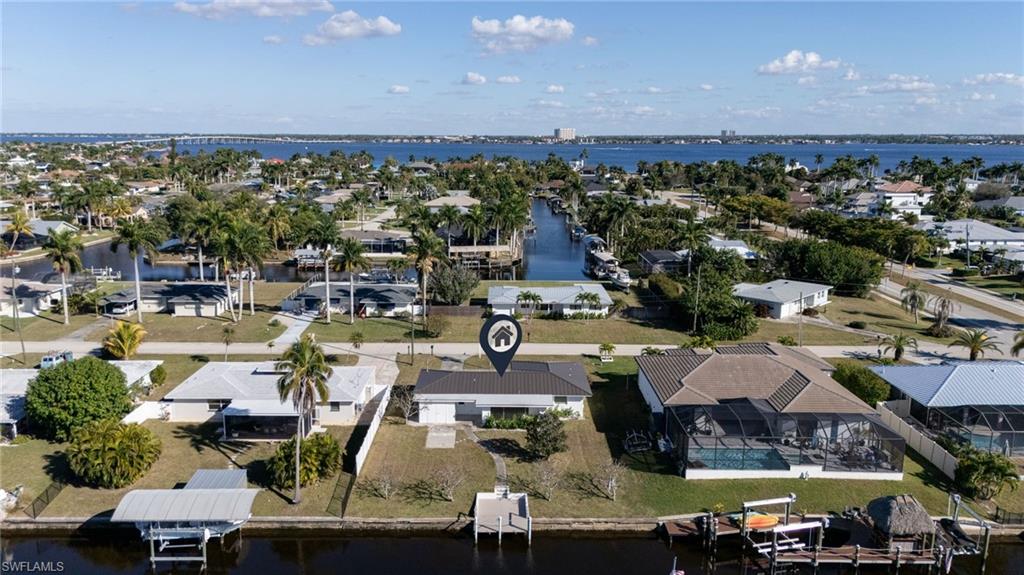 Aerial perspective of suburban area featuring a large body of water