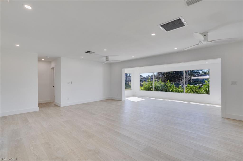 Spare room featuring a ceiling fan, light wood finished floors, and recessed lighting
