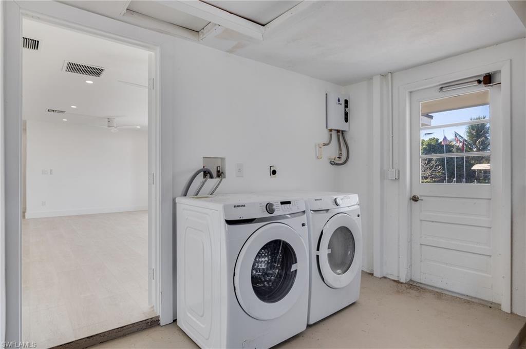 Washroom with washing machine and dryer and water heater