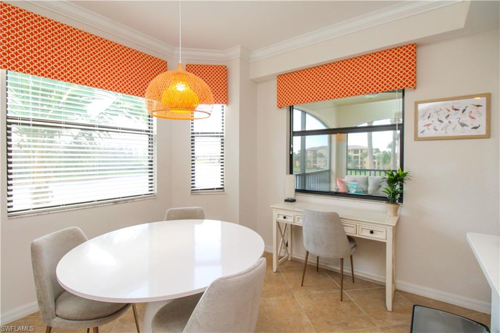 Tiled dining room featuring crown molding