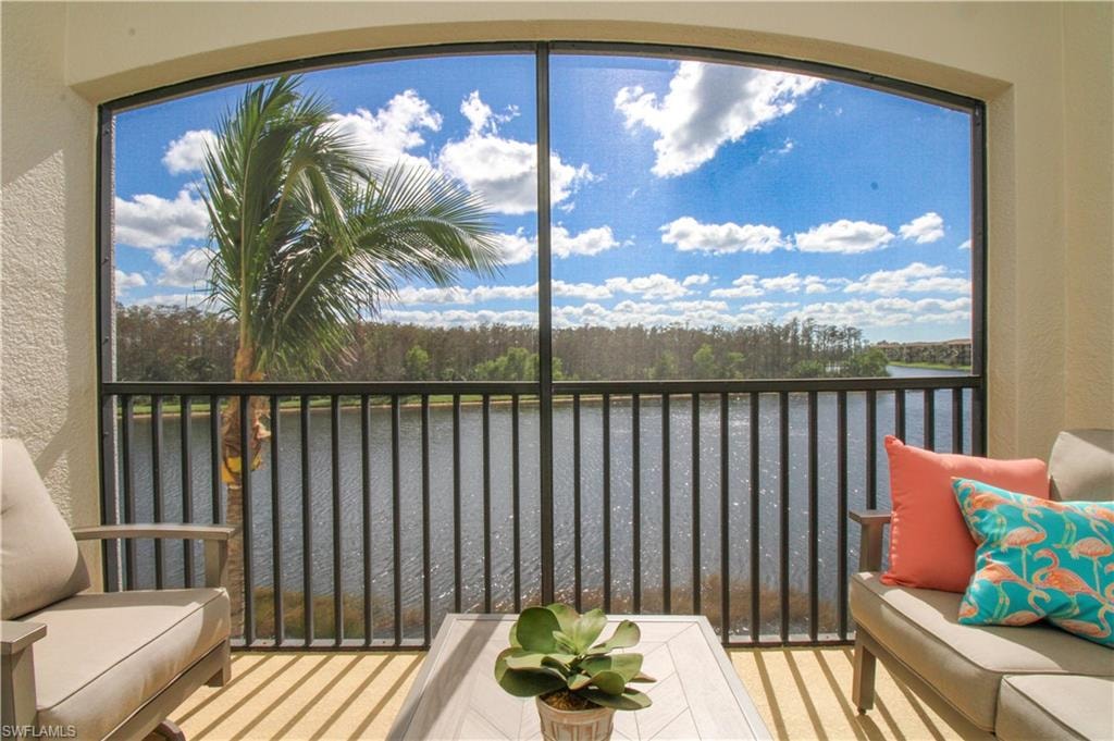 Sunroom / solarium featuring plenty of natural light and a water view