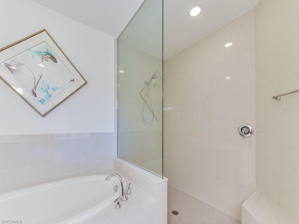 Full bath with a bath, walk in shower, and recessed lighting