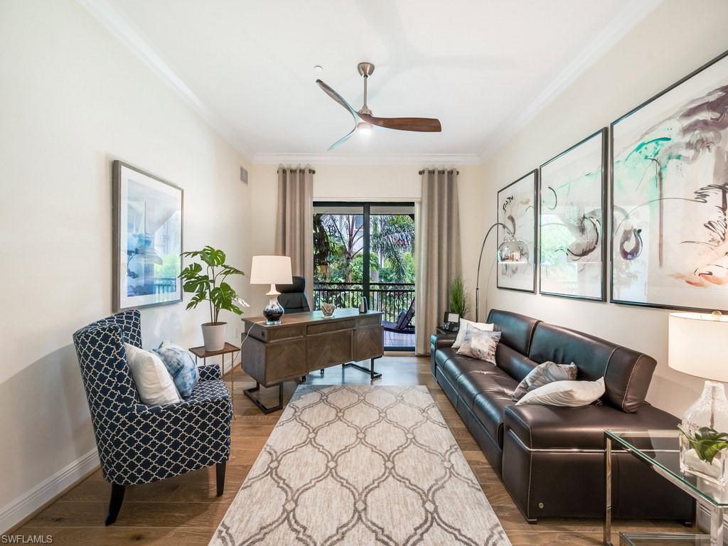 Office space featuring ornamental molding, a ceiling fan, and light wood finished floors