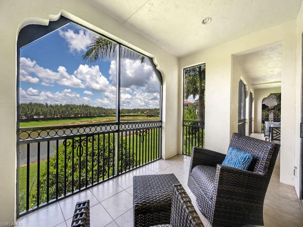 Sunroom featuring view of scattered trees