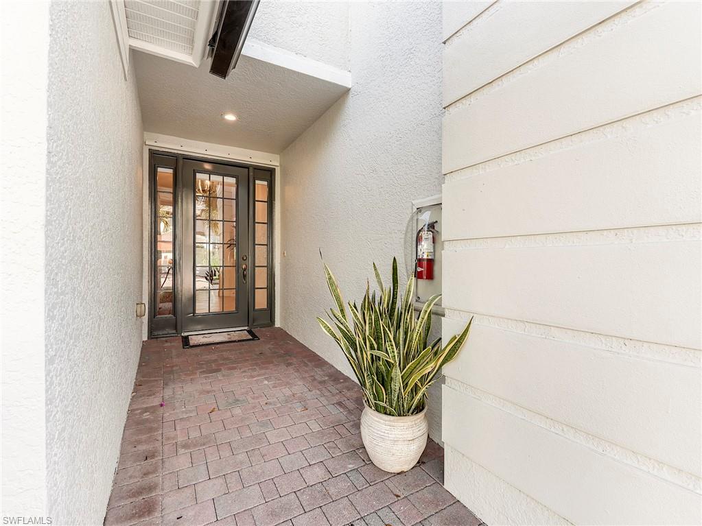 Entrance to home featuring stucco siding