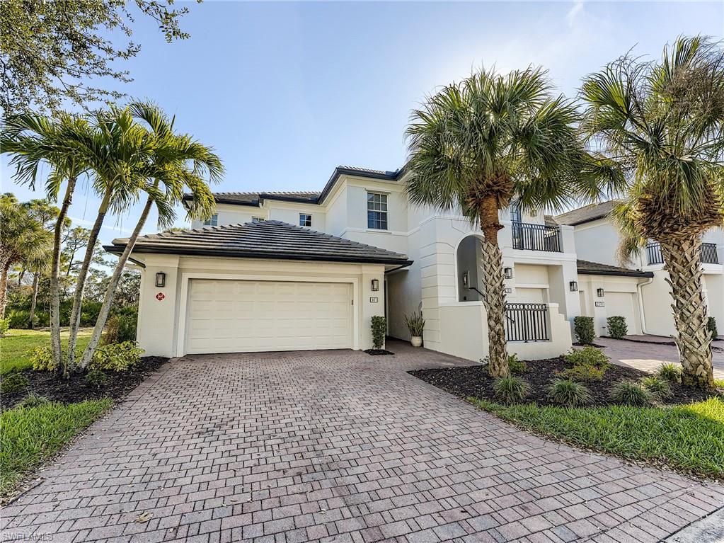 Mediterranean style home featuring decorative driveway, stucco siding, and an attached garage