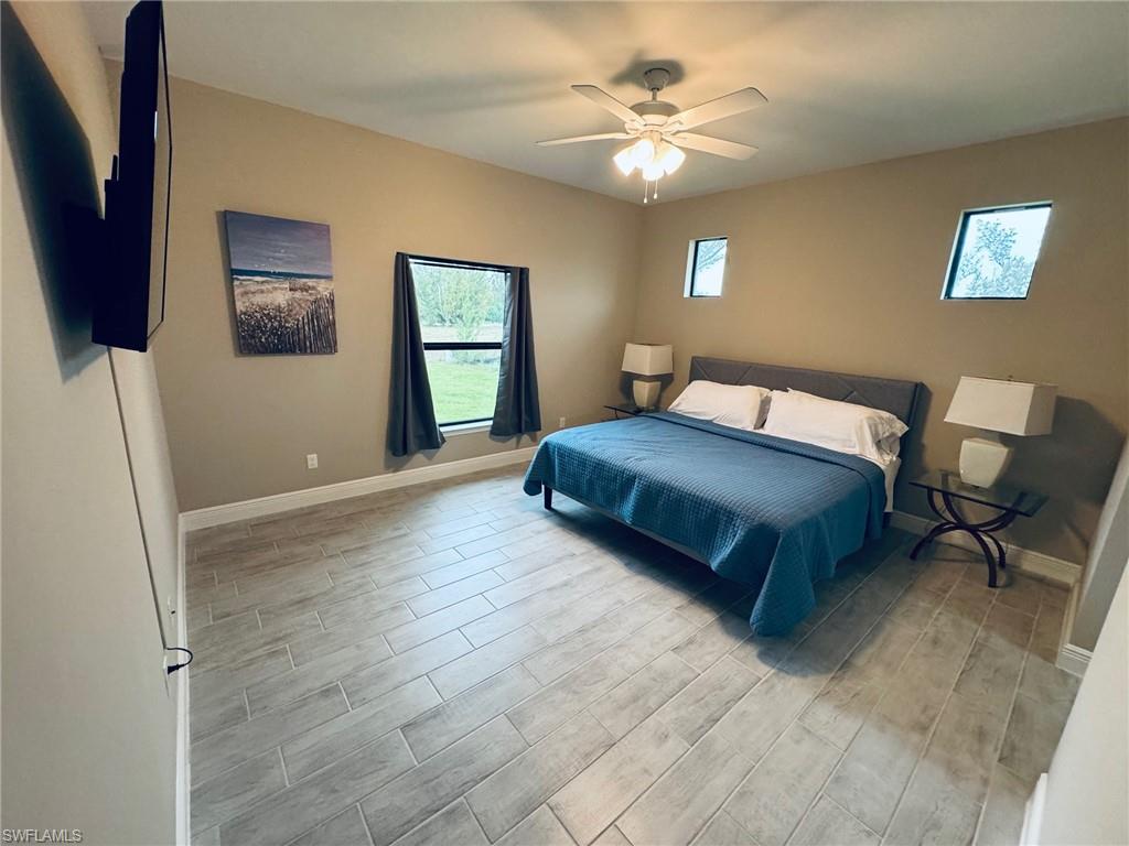 Bedroom featuring wood tiled floors and ceiling fan