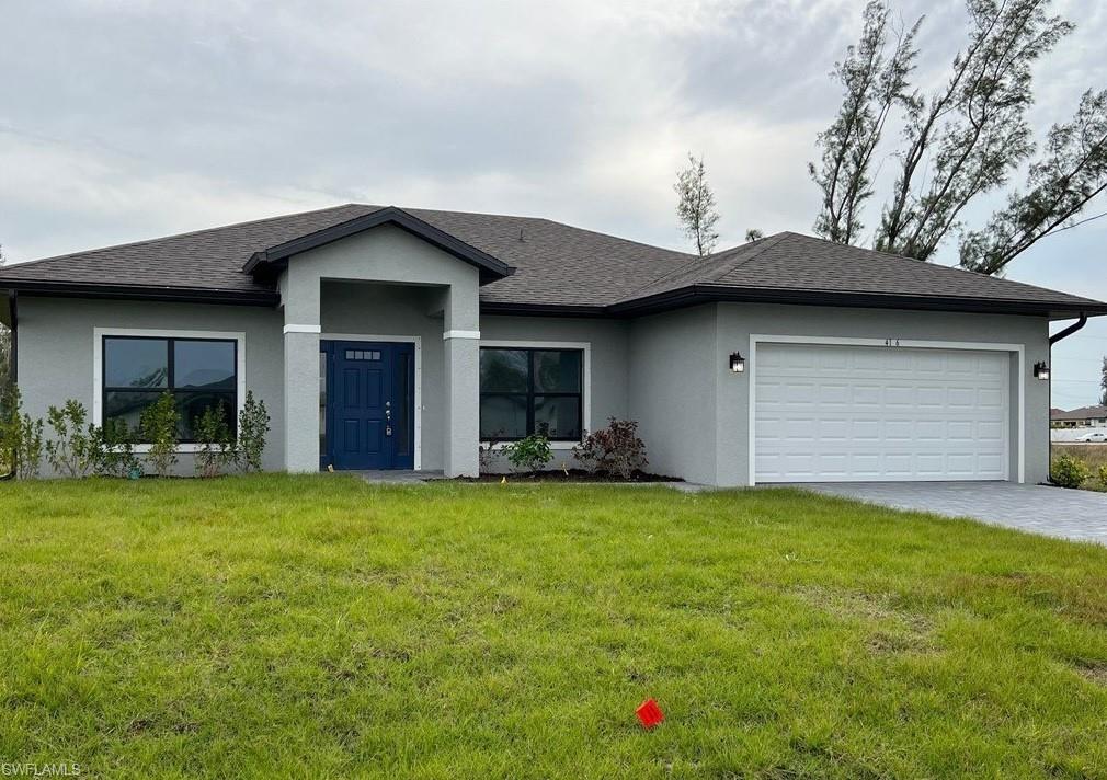 Ranch-style home featuring a front yard, an attached garage, stucco siding, roof with shingles, and decorative driveway