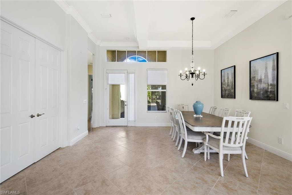 Dining room featuring a chandelier, beamed ceiling, and light tile patterned flooring