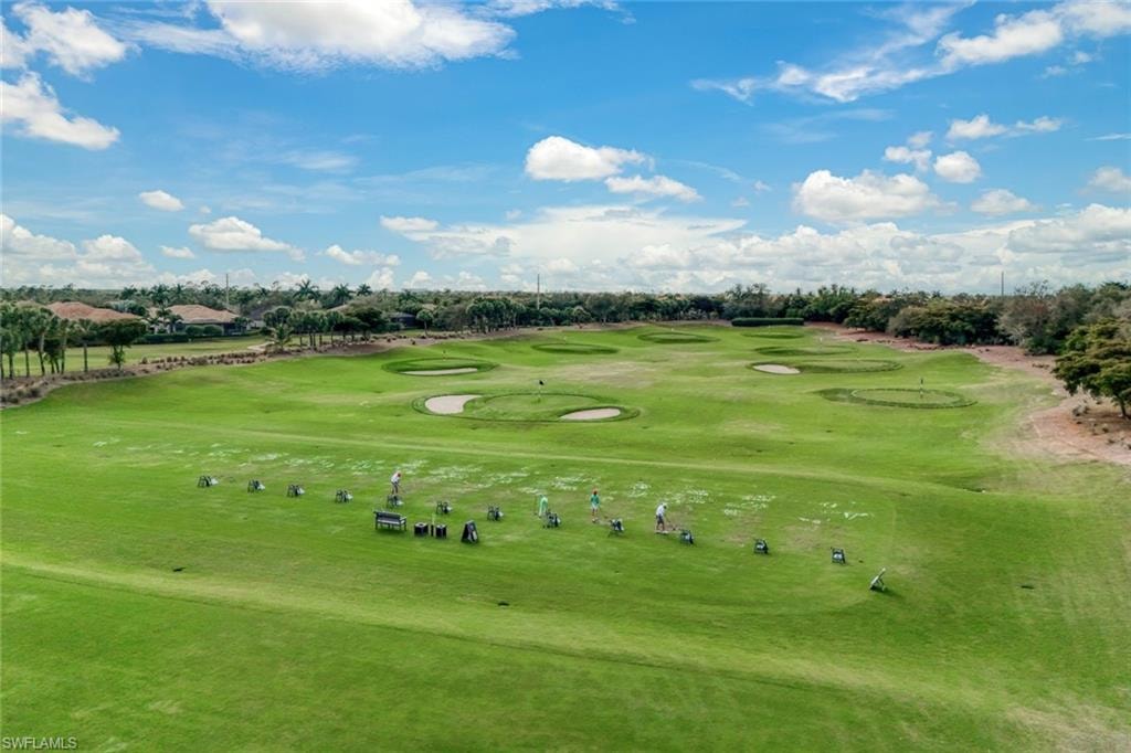 View of community featuring golf course view and view of wooded area