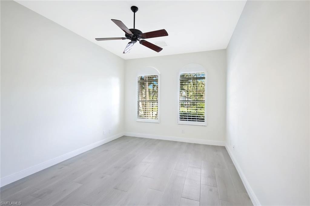 Unfurnished room with light wood finished floors and ceiling fan