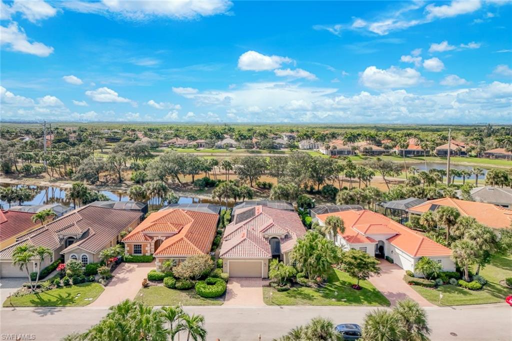 Aerial view of residential area featuring a nearby body of water
