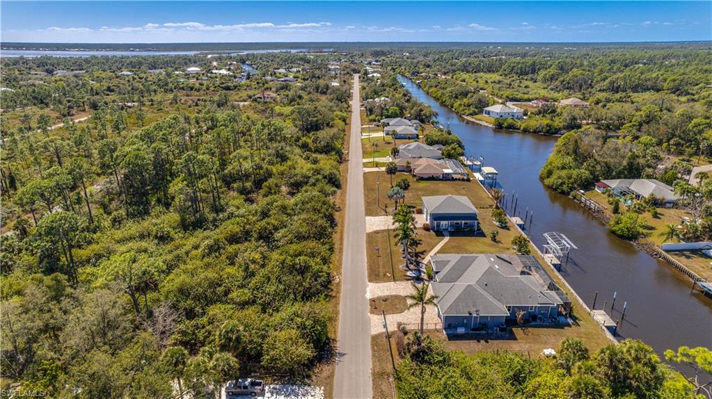 Aerial perspective of suburban area featuring a large body of water