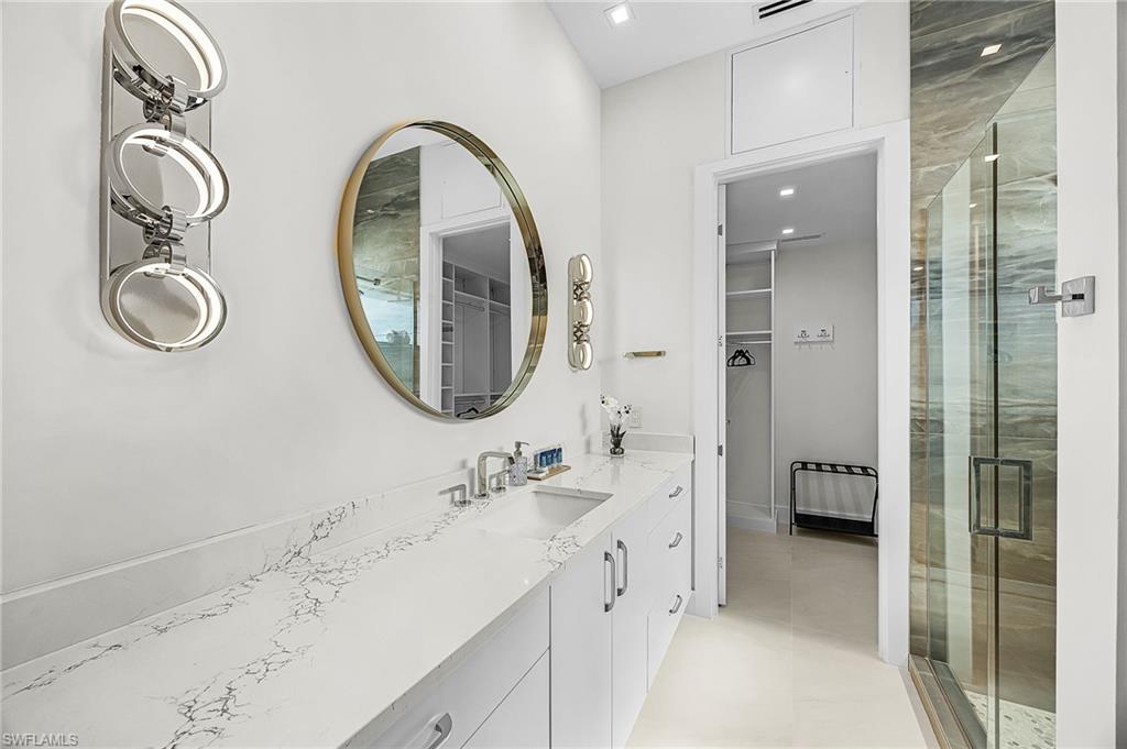 Full bath with a spacious closet, vanity, and a stall shower - Virtually Edited Image