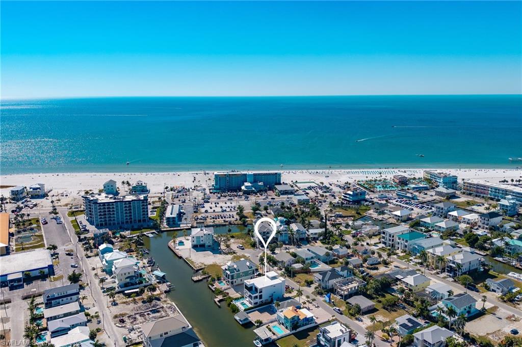 Aerial overview of property's location featuring a large body of water and nearby urban area - Virtually Edited Image