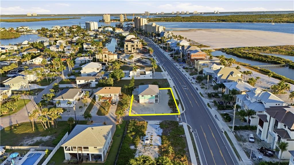 View of urban area featuring property boundaries highlighted and nearby suburban area - Virtually Edited Image