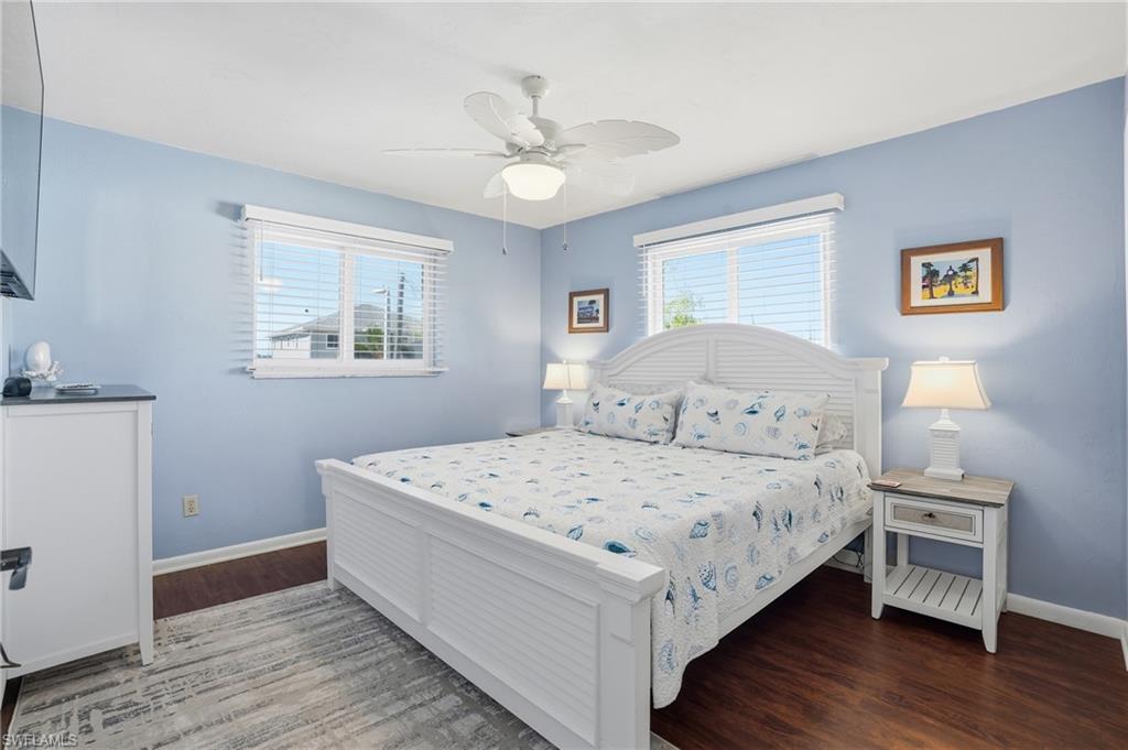Bedroom with ceiling fan and wood finished floors - Virtually Edited Image