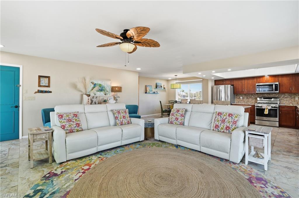 Living area featuring a ceiling fan and recessed lighting - Virtually Edited Image
