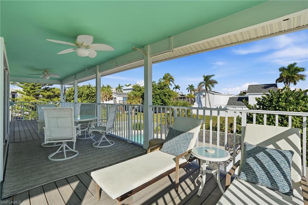 Wooden deck with ceiling fan and outdoor dining space - Virtually Edited Image