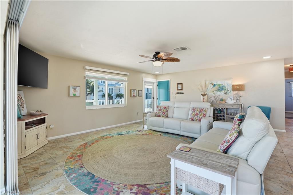 Living area featuring ceiling fan and recessed lighting - Virtually Edited Image