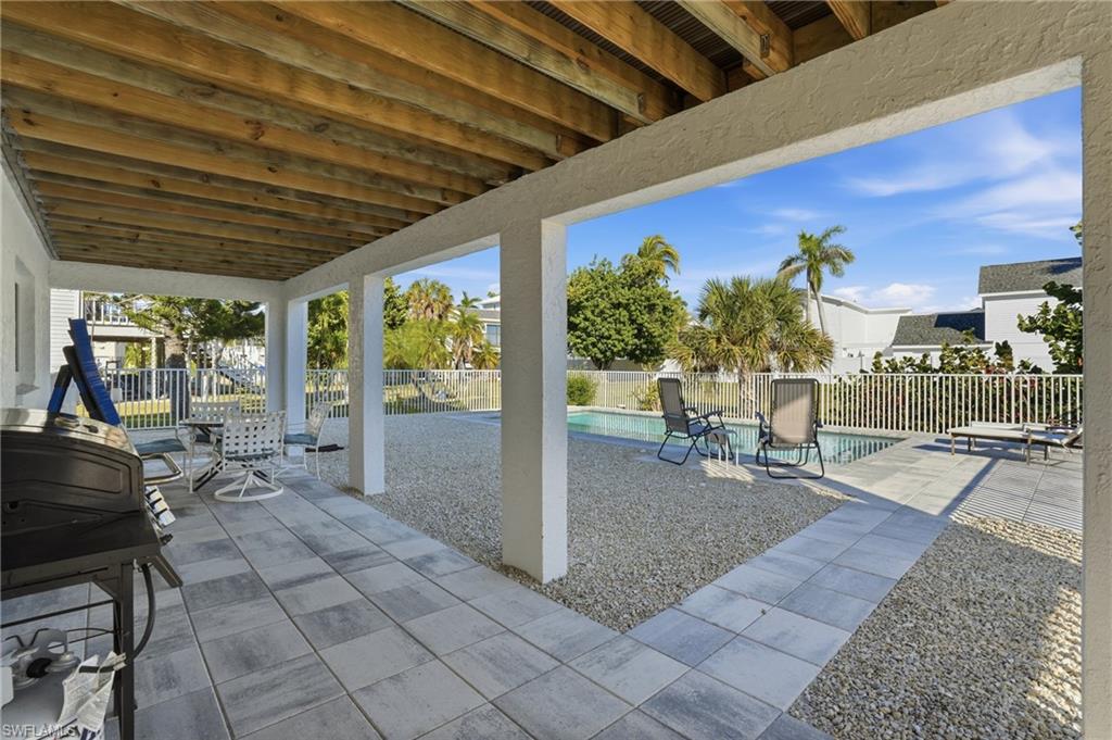 Fenced backyard with a patio area and grilling area - Virtually Edited Image
