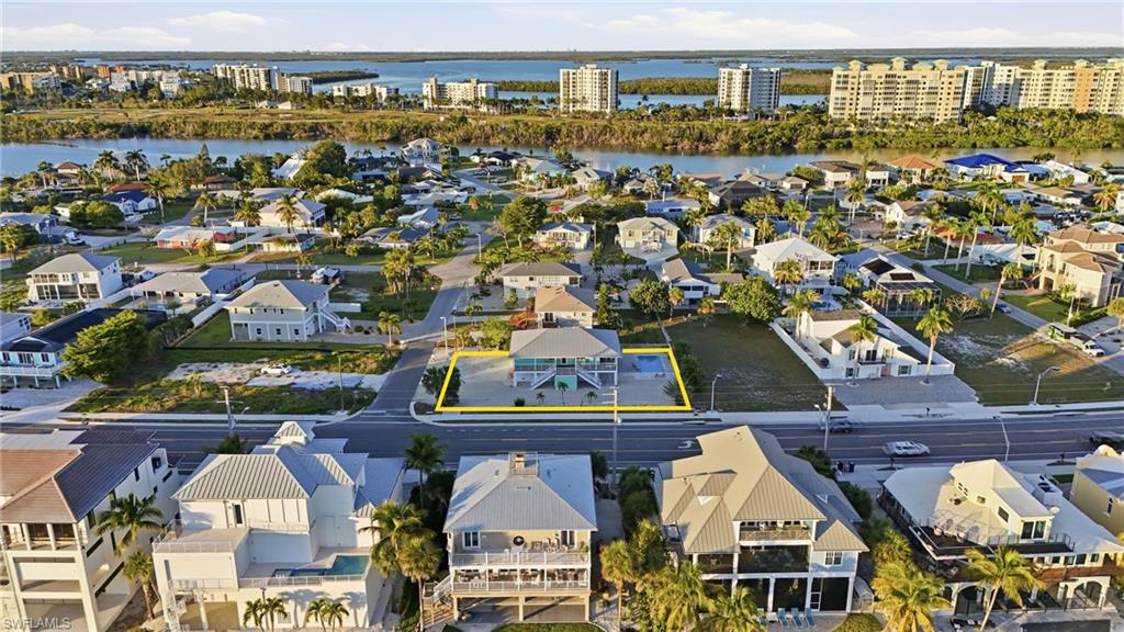 Aerial perspective of suburban area featuring a large body of water - Virtually Edited Image