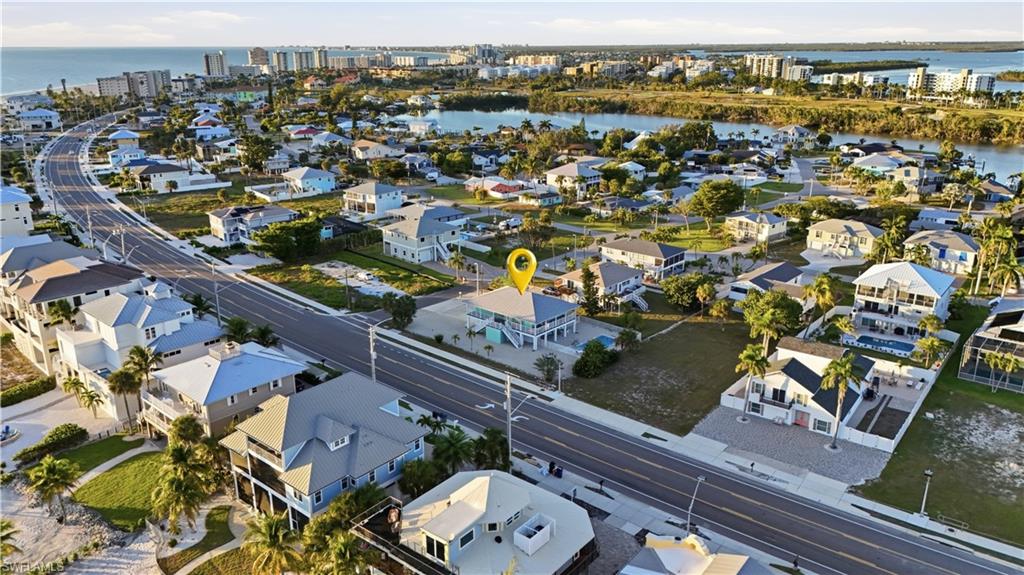 View of property location featuring a nearby body of water and nearby suburban area - Virtually Edited Image