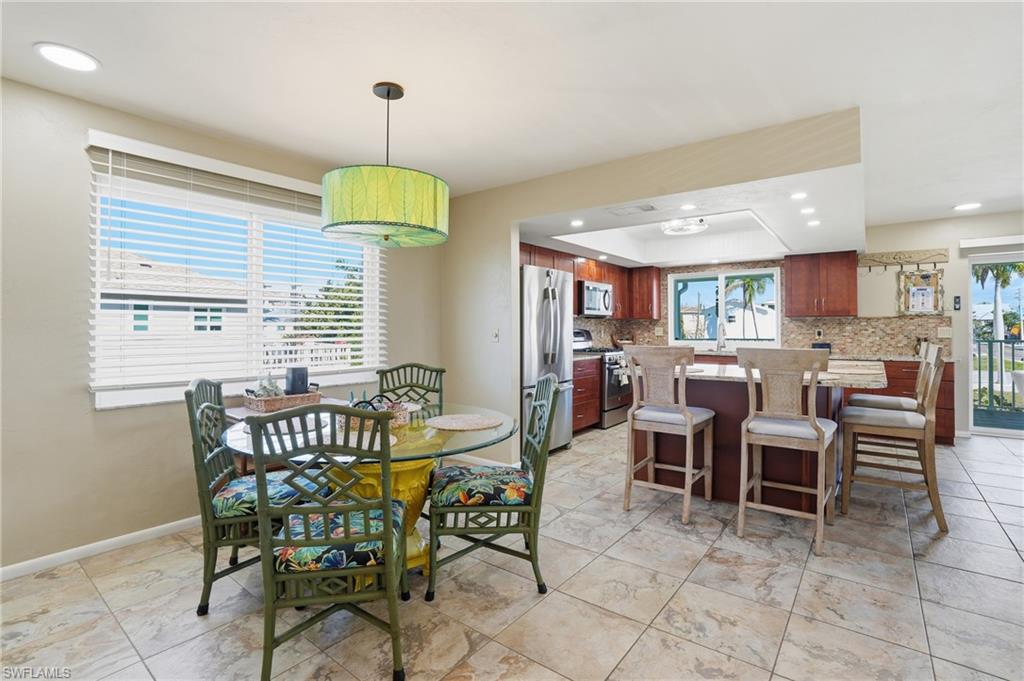 Dining space with recessed lighting and baseboards - Virtually Edited Image