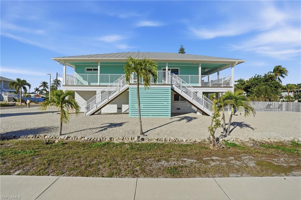 Raised beach house with stairs and a porch - Virtually Edited Image