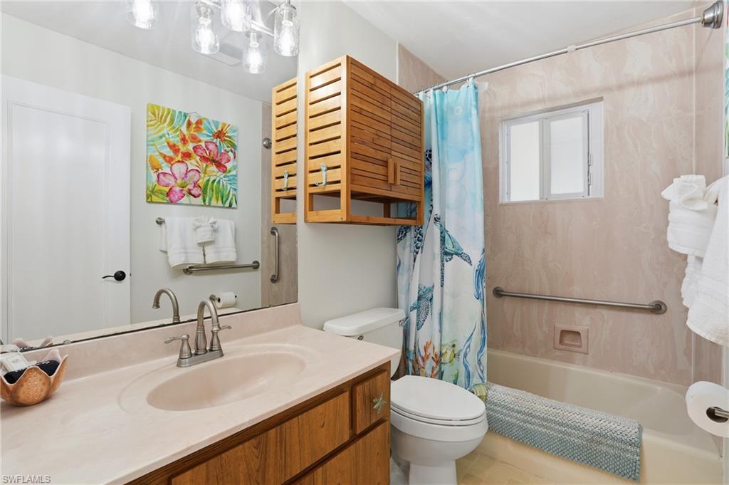 Bathroom featuring vanity and shower / bath combination with curtain - Virtually Edited Image