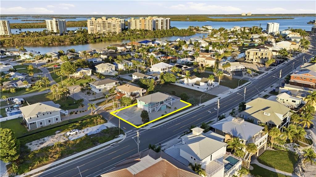 Aerial view of residential area with a large body of water - Virtually Edited Image