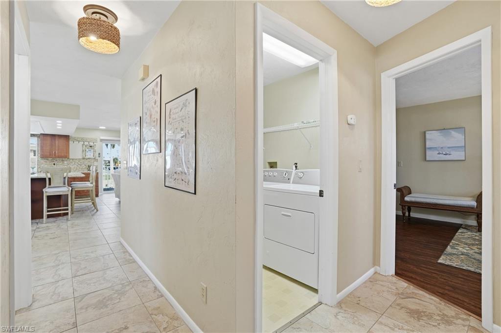 Hall with light marble finish floors and baseboards - Virtually Edited Image