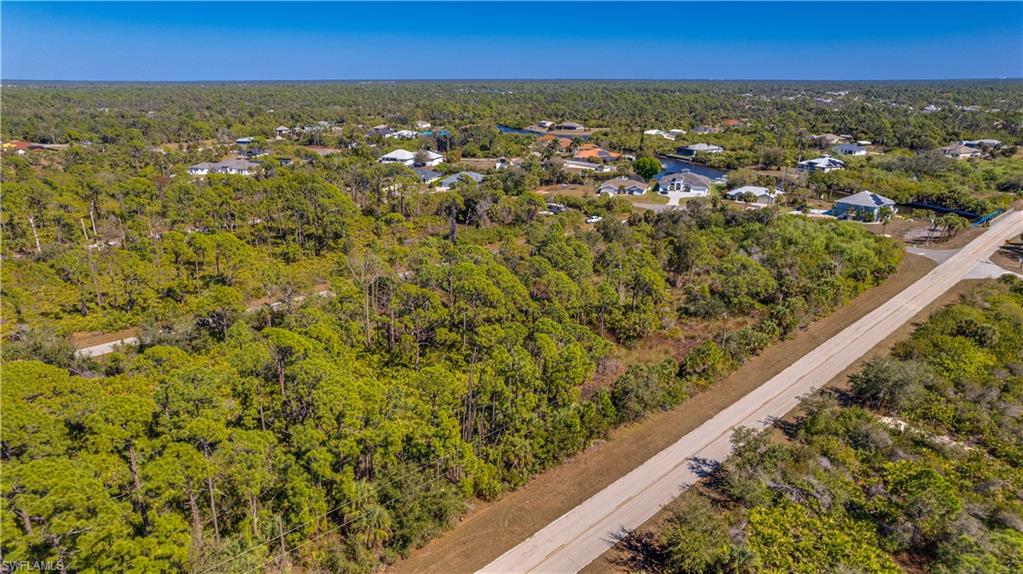 Aerial view of residential area featuring a heavily wooded area