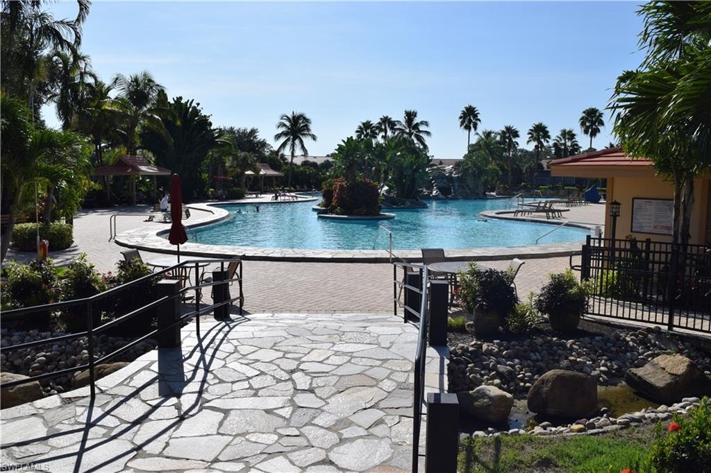 Community pool with a patio area and a gazebo