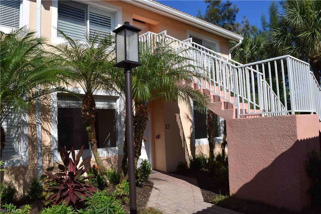 Doorway to property featuring stucco siding