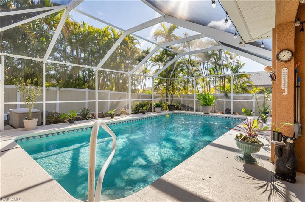 View of pool with a lanai, a fenced backyard, a patio, and a sunroom