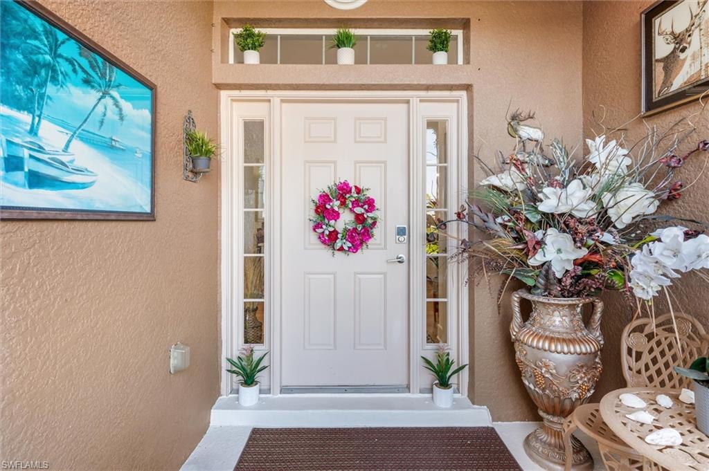 Doorway to property with stucco siding
