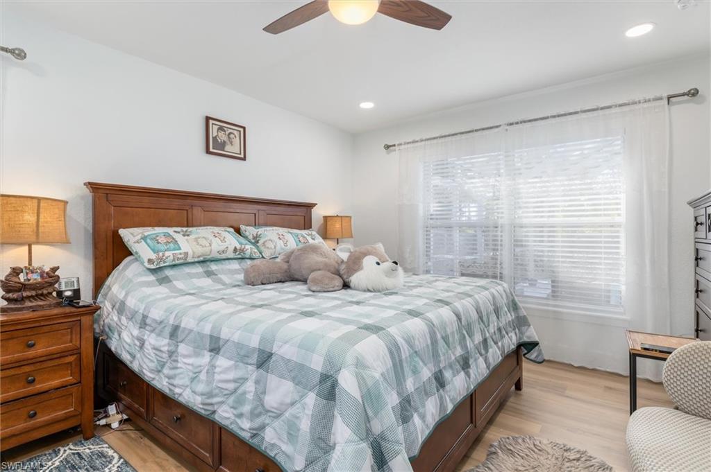 Bedroom featuring light wood-style flooring, a ceiling fan, and recessed lighting
