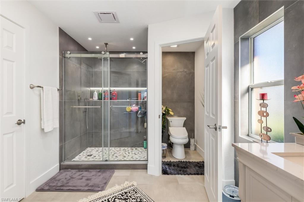 Bathroom featuring vanity and a shower stall