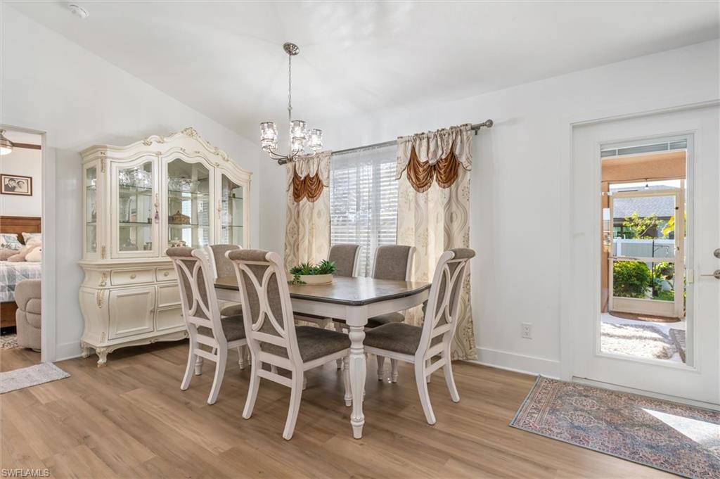 Dining space featuring light wood-style floors and a chandelier