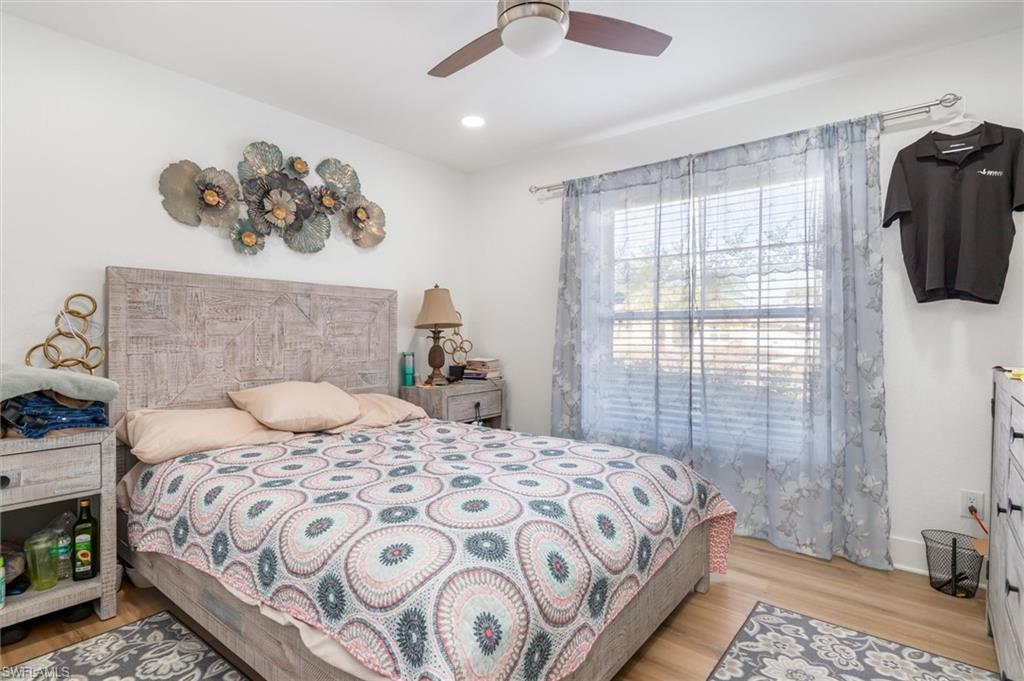 Bedroom with light wood-style flooring, a ceiling fan, and recessed lighting