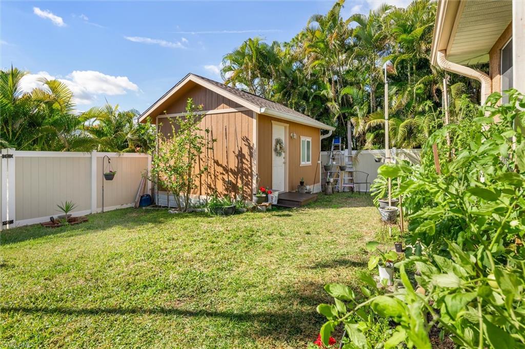 Fenced backyard with a gate and a storage shed