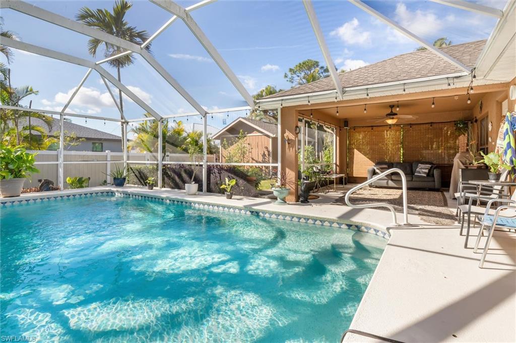 View of swimming pool featuring a lanai, a patio, a sunroom, and an outdoor hangout area
