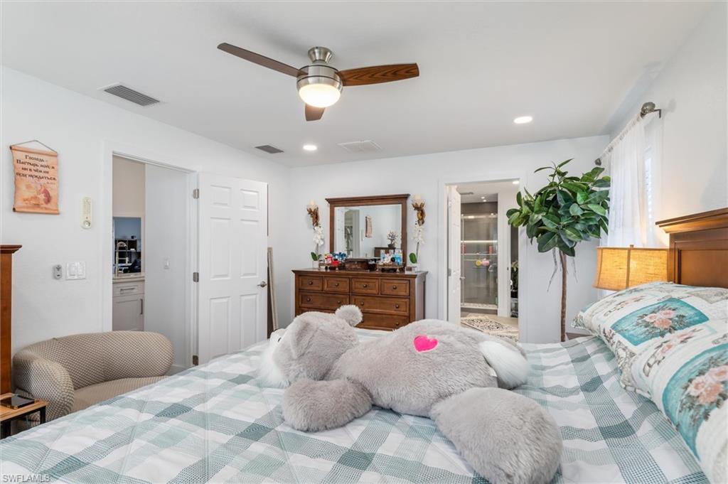 Bedroom with ensuite bathroom, ceiling fan, and recessed lighting