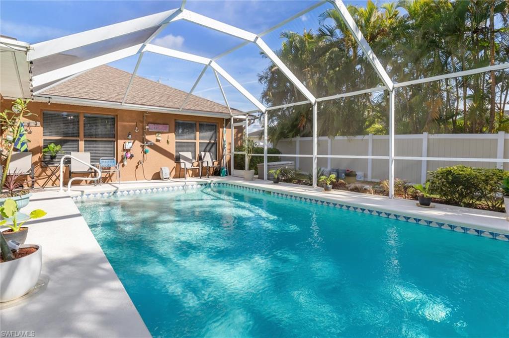 View of pool featuring a lanai, a patio, and a sunroom