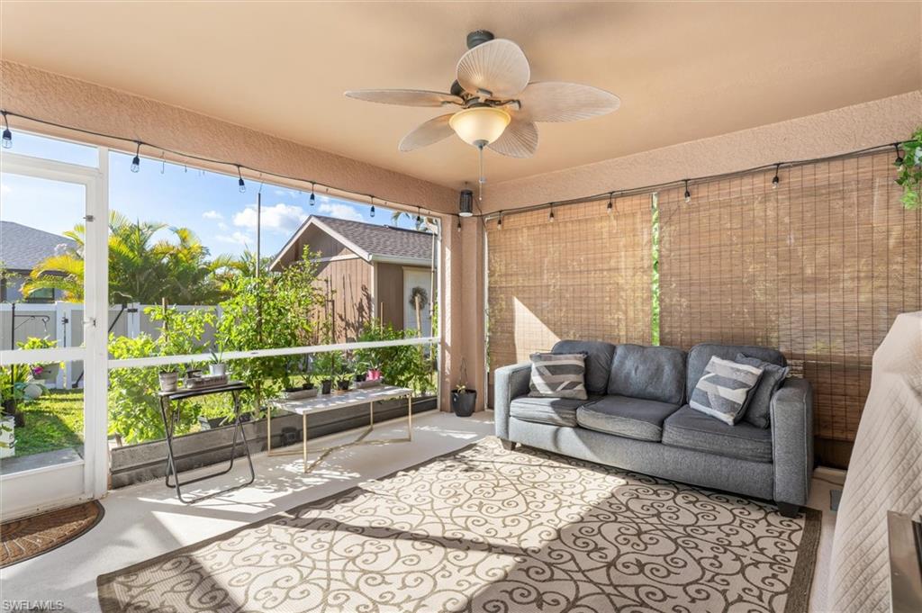Sunroom / solarium featuring a ceiling fan and outdoor lounge area