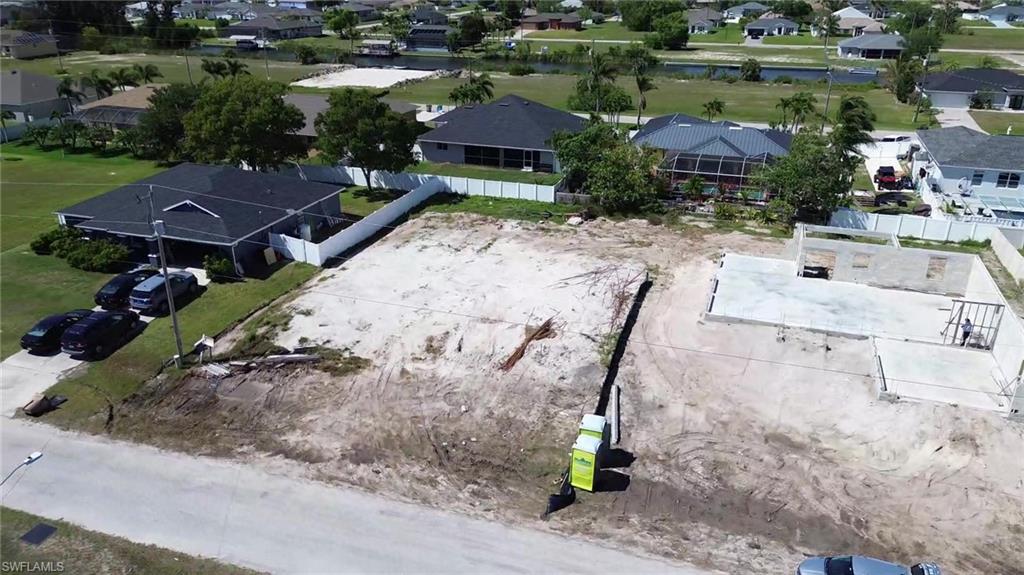 Aerial view of residential area featuring a nearby body of water