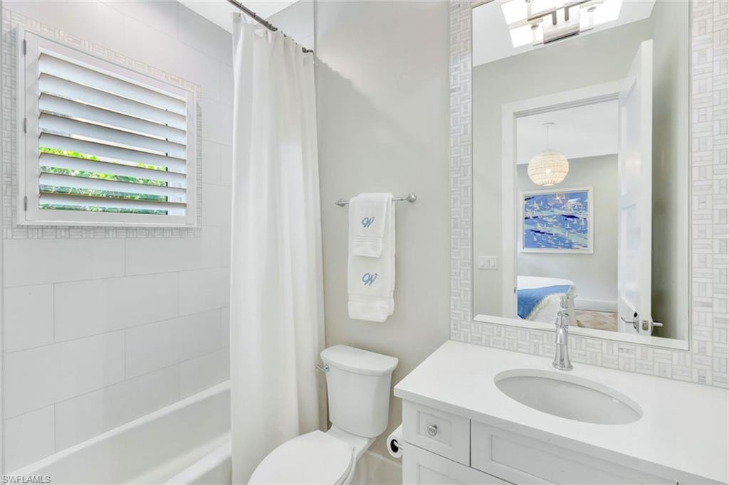 Ensuite bathroom featuring shower / bath combo and vanity