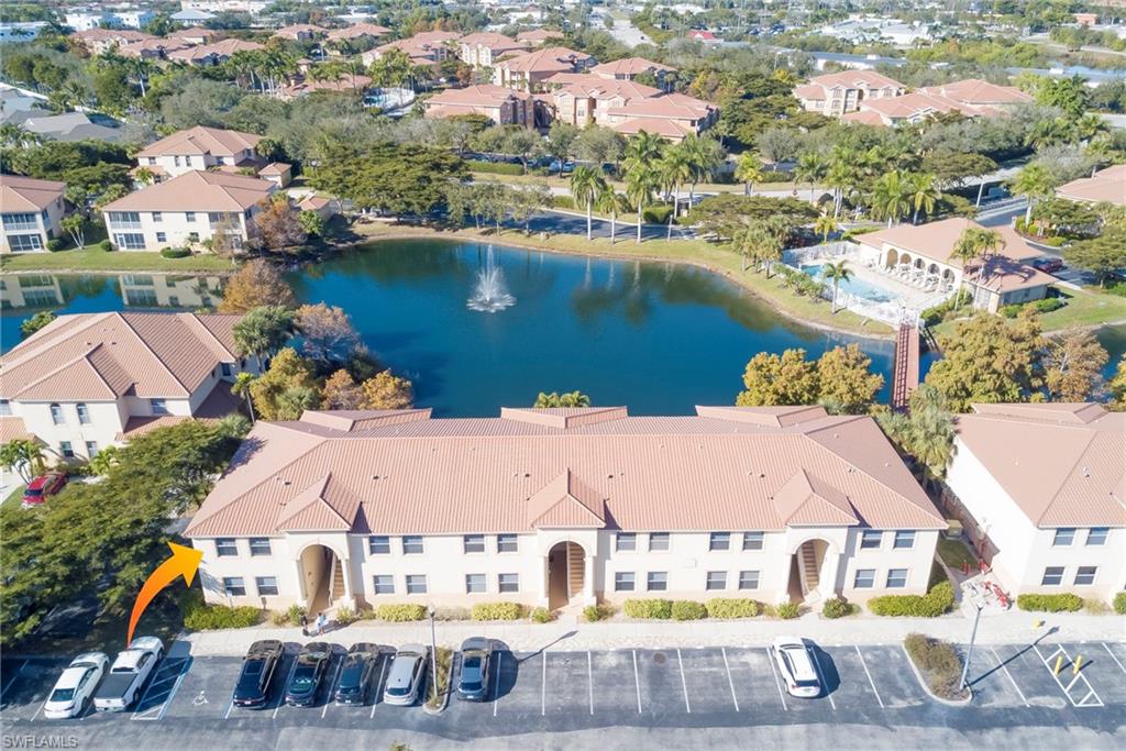 Aerial view of residential area featuring a nearby body of water