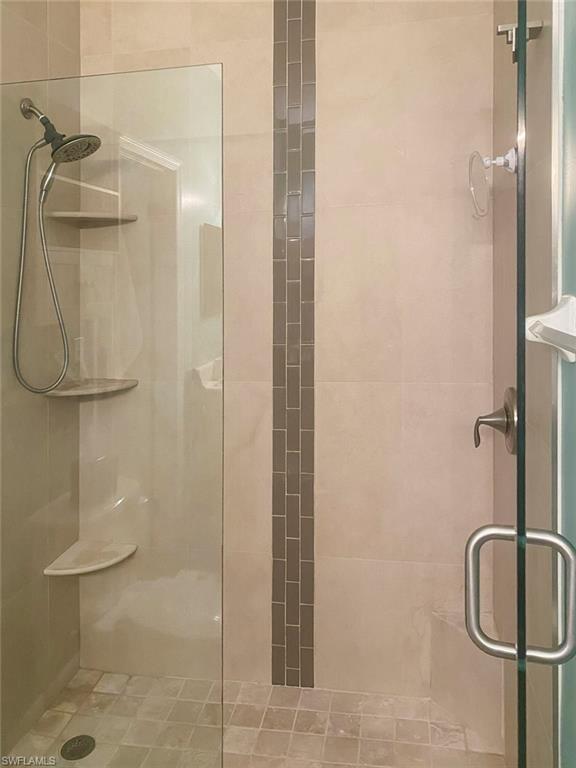 Full bath featuring a shower stall